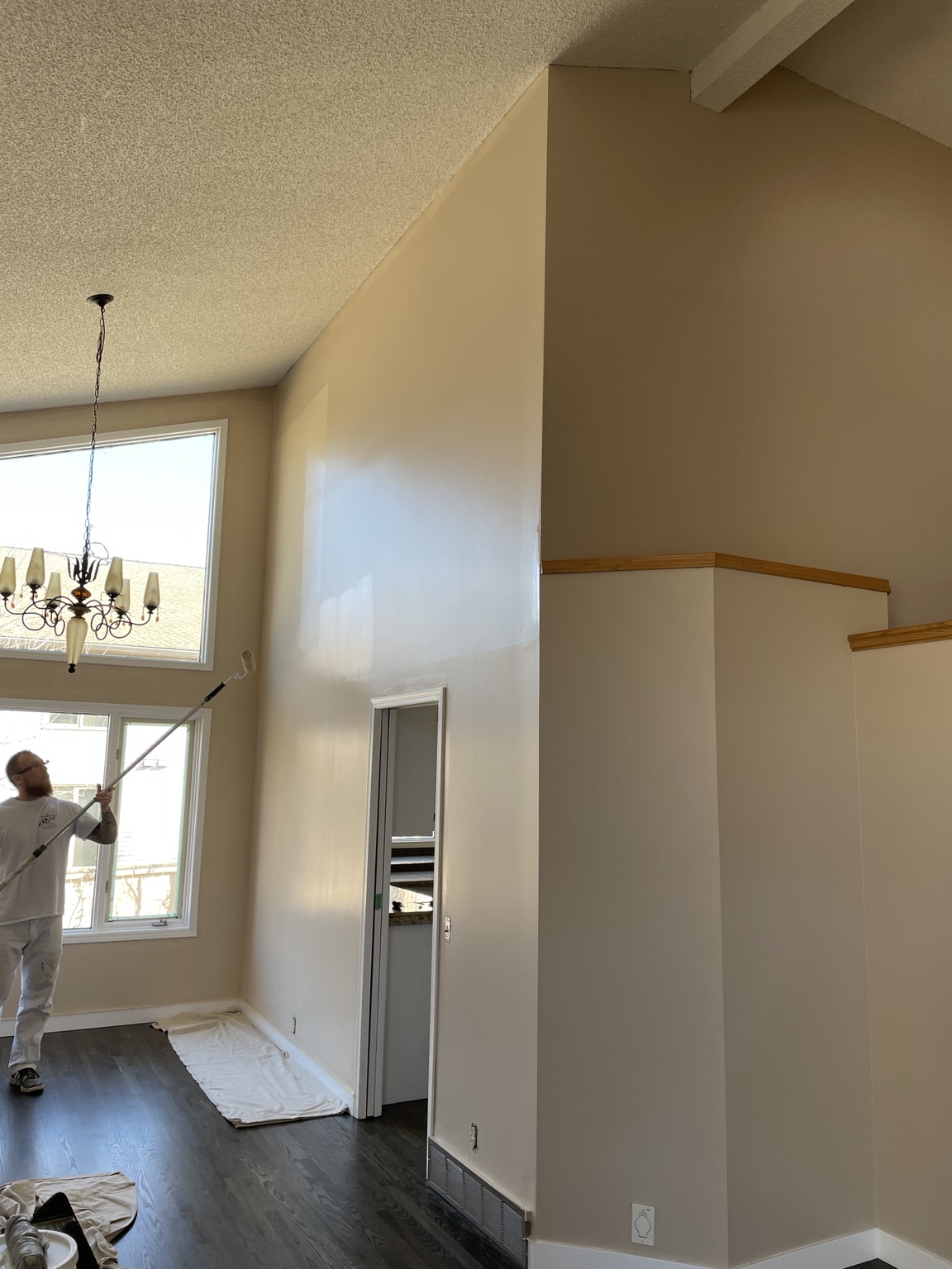 Interior repaint project with painter using roller